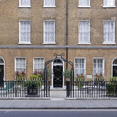 Montcalm Brewery Townhouse Hotell London Eksteriør bilde The photo shows a row of three-story brick buildings, featuring a classic design with large windows and decorative ironwork. The buildings are painted in a muted yellow-brown color, typical of older urban architecture. In front of the buildings, ther