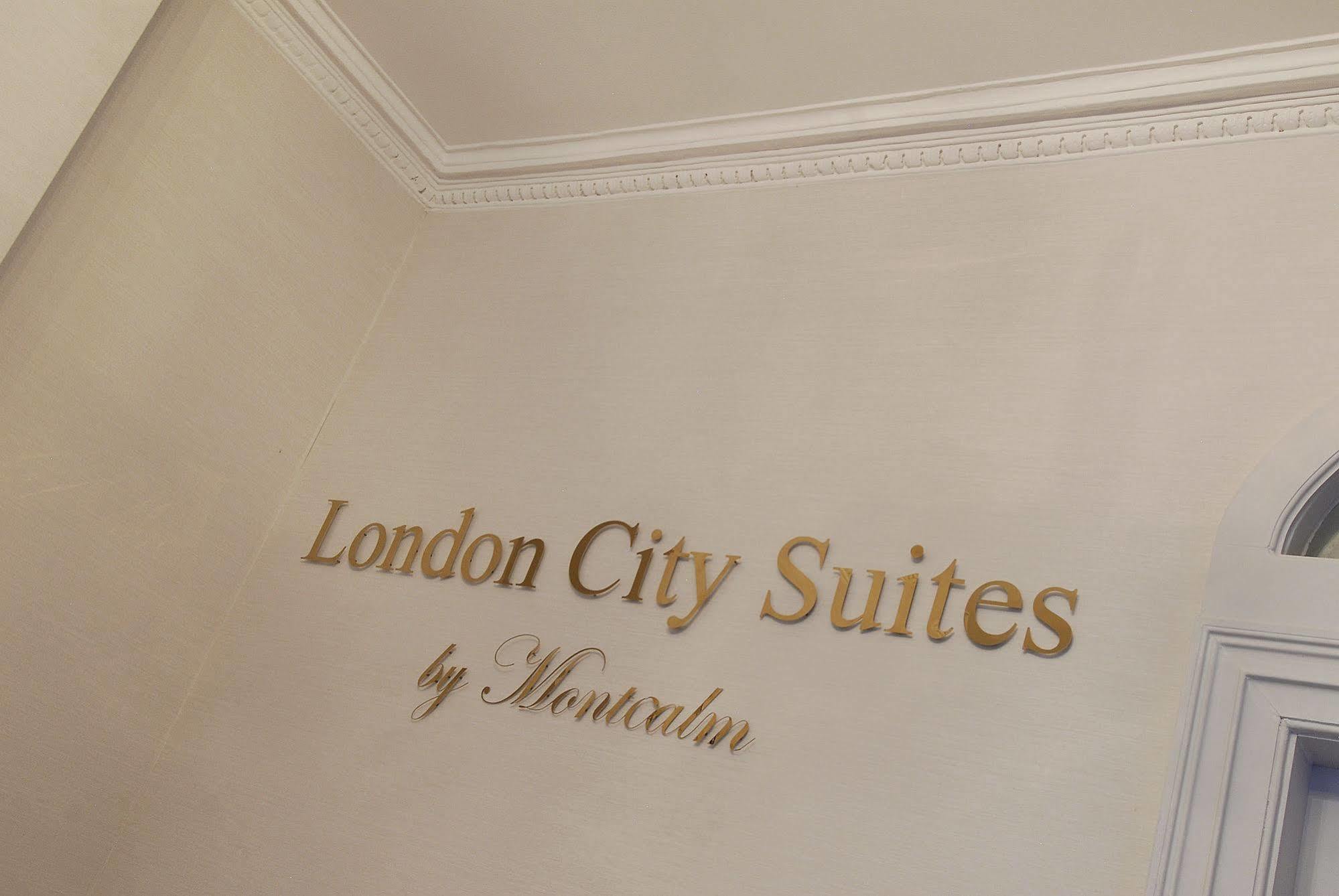 Montcalm Brewery Townhouse Hotell London Eksteriør bilde The photo shows a wall display featuring the text "London City Suites" in a bold, gold-colored font. Below that, the words "by Montcalm" are written in a smaller, elegant style. The background appears to be a neutral-colored wall, possibly in a hotel
