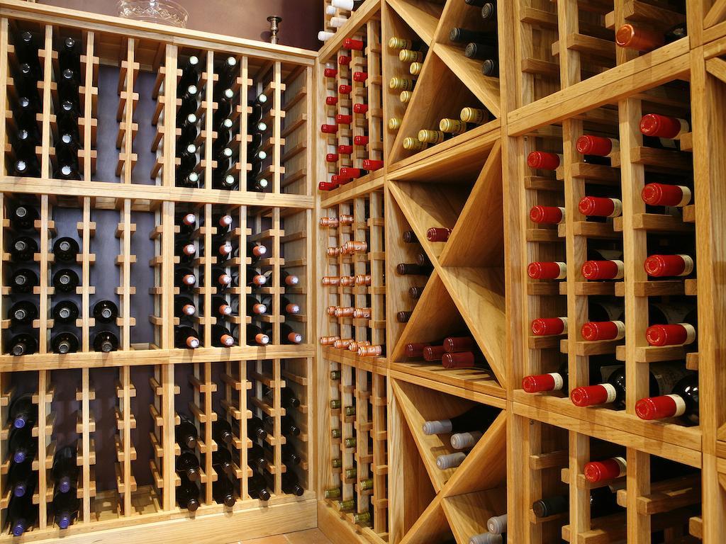 Montcalm Brewery Townhouse Hotell London Eksteriør bilde The photo shows a wine cellar with wooden racks designed for storing wine bottles. The structure is divided into sections, featuring various compartments that hold the bottles in an organized manner. The bottles have different colors, with many red a